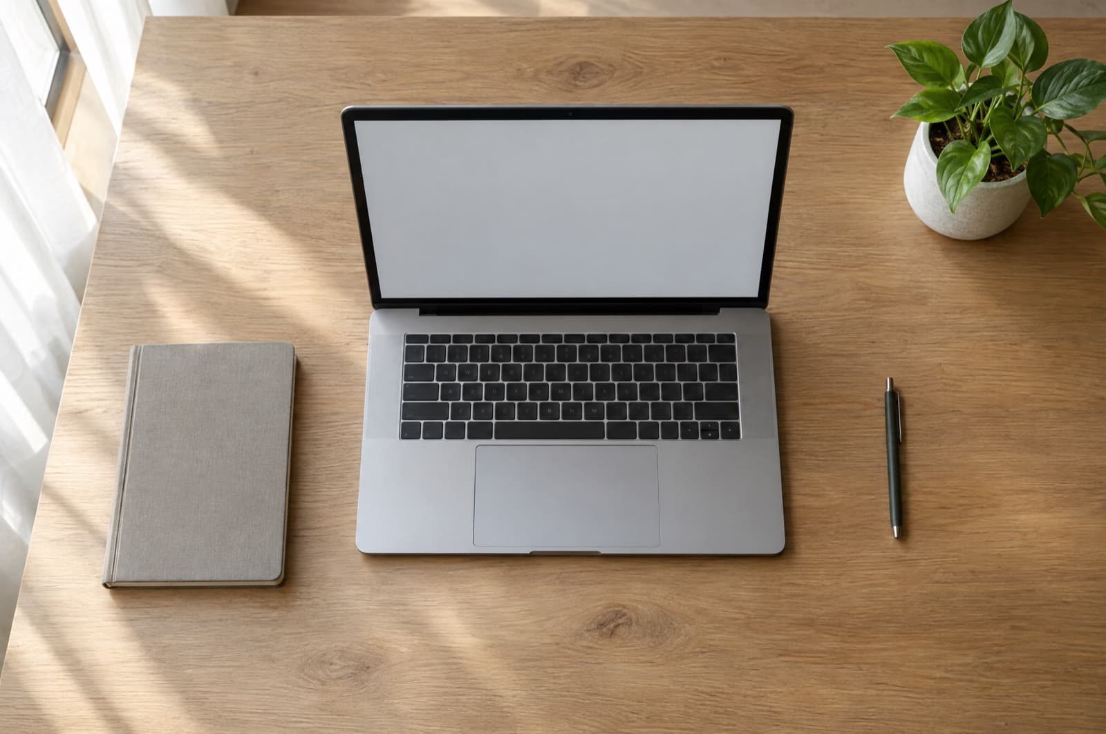 A tidy desk with a laptop and a few labelled folders